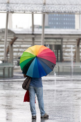 Man with rainbow umbrella
