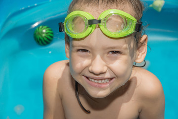 Little girl in swimming pool with goggles