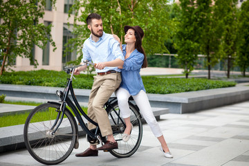 Fototapeta premium Young couple sitting on a bicycle 