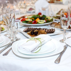 serviette on a plate on the holiday table served with various di