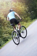 Obraz premium Man riding a bike uphill