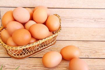 Eggs in the basket on wooden background