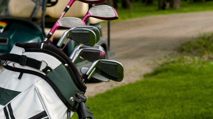 Vertical dolly shot of golf equipment and golf car