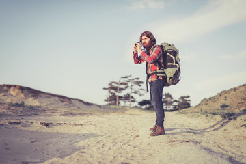 Photographer standing on a sandy trail