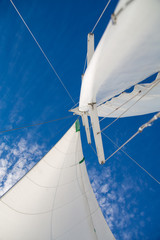 View of the sails and mast against the sky.