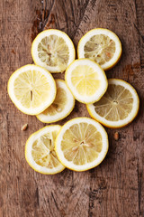 Fototapeta na wymiar stack of citrus fruit slices. lemons. On wooden table