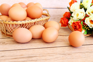 Eggs in the basket on wooden background