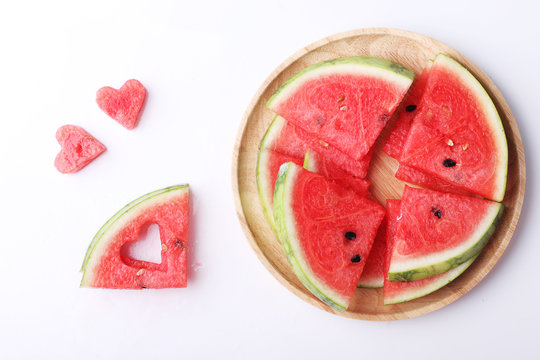 Slices of fresh watermelon with heart shape pieces