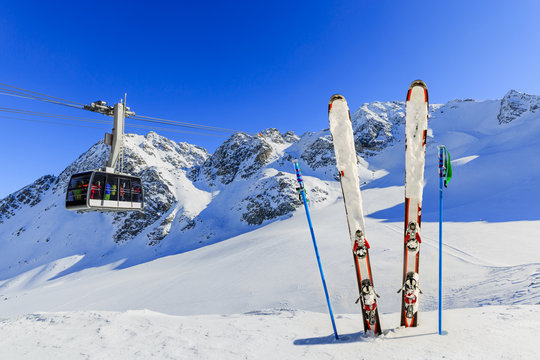 Skiing - mountains, cable car and ski equipments on ski run
