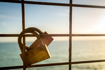 Rusty love locks hanging on the fence as a symbol of loyalty and - Powered by Adobe