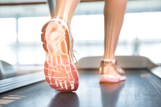 Highlighted foot of woman on treadmill
