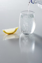 Sparkling Water in Glass Being Poured
