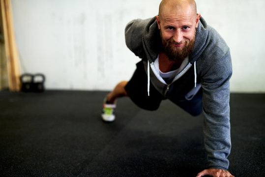 Strong man doing one arm pushup