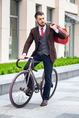 Fototapeta na wymiar Handsome businessman and his bicycle