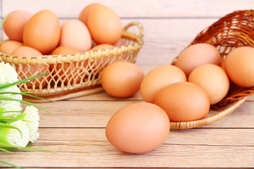 Eggs in the basket on wooden background