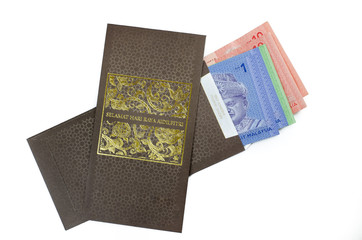 'Duit Raya' is money given from adult to children during Eid al-Fitr celebration in Malaysia. This is a Malay tradition and regarded as alms to the children.