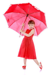 Portrait in red, adorable little girl holding an umbrella