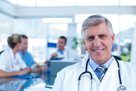 Smiling doctor looking at camera