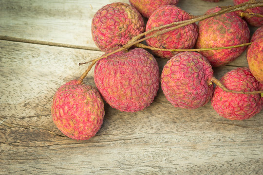 fresh lychees on wooden background