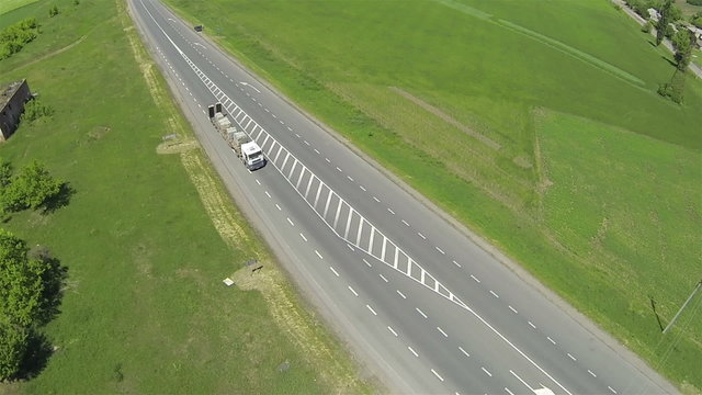  truck  with  stone blocks jn highway. Aerial  panorama