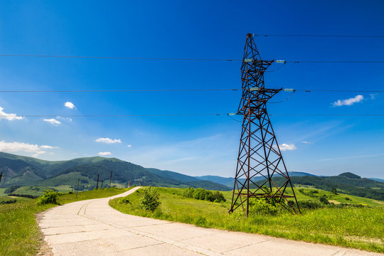 High voltage power lines tower in mountains