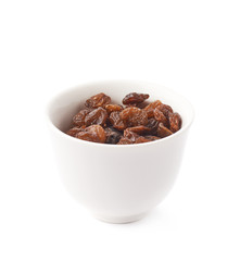Cup filled with raisins isolated