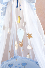 Hanging wooden toys in the crib.