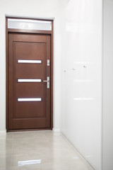 Wooden door in white hall