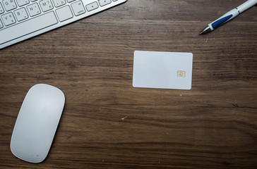 Top view of office table with keyboard, pen,mouse and credit card.