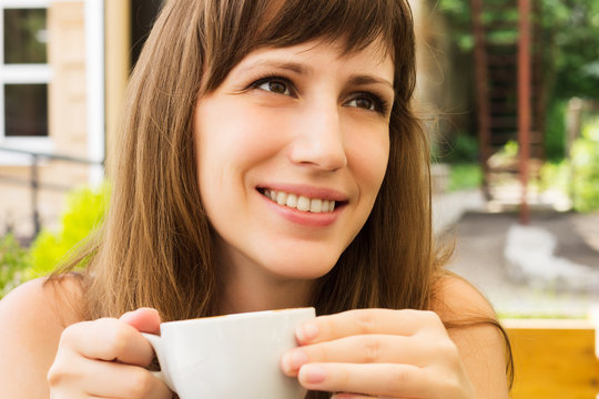 Portrait of young woman smiling in cafe