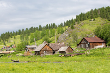 Panorama of the old village at the foot of a green hill