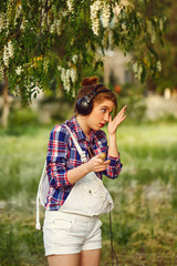 Girls hipster headphones corrects makeup.