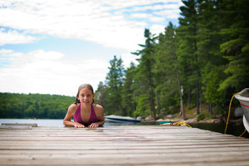 young teenage girl on a dock at a lake in Ontario's cottage country