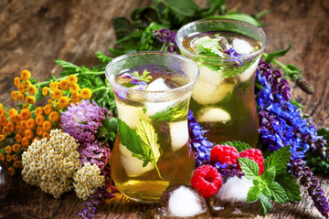 Herbal flower iced tea with raspberries and ice in Islamic glass
