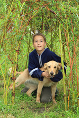 boy and dog in the grass