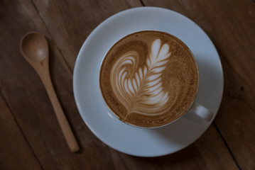 coffee latte art on the wood desk vintage color