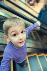 Cute little boy on escalator