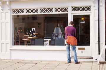 Shop owner opening up record, CD and hi-fi shop