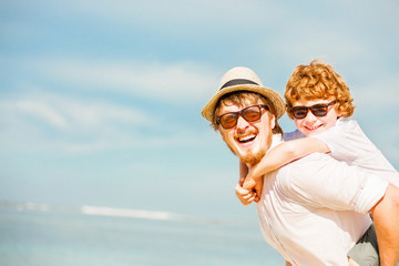 Hipster father with beard and red haired son having happy summer