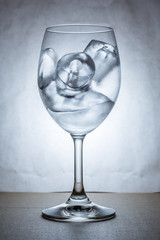 Wine glass with ice in cool tone