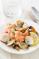 seafood salad on plate with glass of water