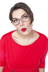 Thoughtful plus size woman in glasses looking on something up