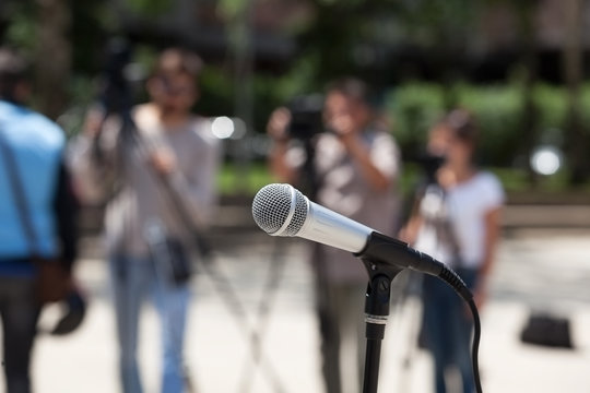Microphone in focus against blurred cameraman