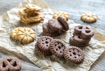 Butter and chocolate chip cookies on the wooden background