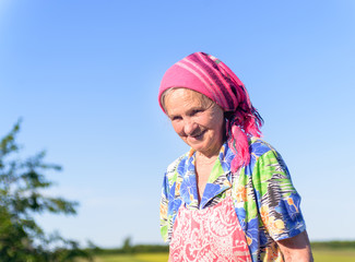 Smiling Senior Female Farmer at the Green Fields