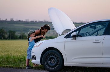 Mother and Son Repairing Something on their Car