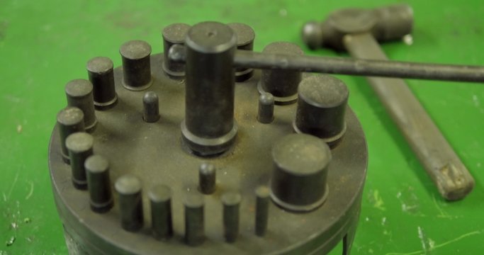 Punch with hammer on table