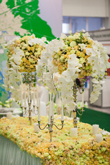 beautiful arrangement of roses with candlesticks on the table