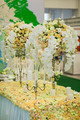 beautiful arrangement of roses with candlesticks on the table