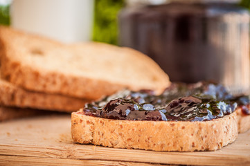 breakfast with sour cherry marmalade on toast with a glass of milk and frutis